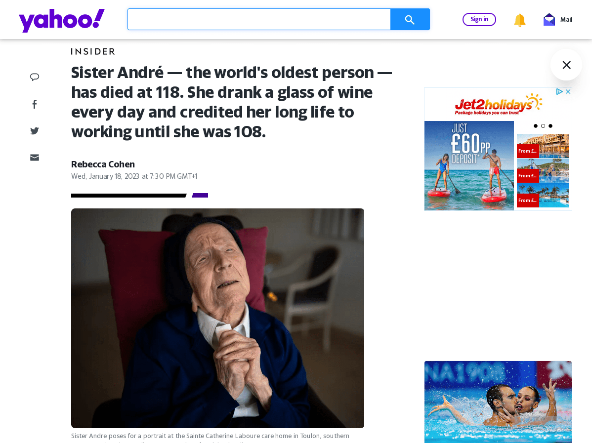 Yahoo! News article titled 'Sister André — the world's oldest person — has died at 118. She drank a glass of wine every day and credited her long life to working until she was 108.' published Wednesday, January 18, 2023. The article's author is listed as Rebecca Cohen. Ads are visible largely down the right column, mimicking the layout of the earlier 1920s New York Times. A similar ratio of space is devoted to the side ad bar as well, roughly 20%. Below the title text is a photo of Sister André, with her hands clasped in a prayer gesture, taken April 27, 2022.
